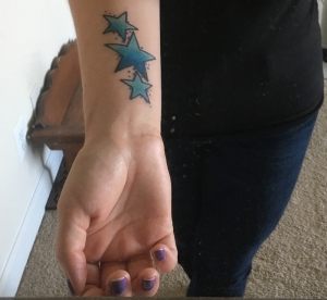 Star tattoo on forearm